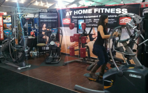 A customer tries out an Octane elliptical machine at the At Home Fitness booth during the Barrett-Jackson Auto Auction that will be going on until Sunday