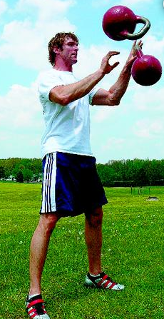 Athletic trainer and strongman Andrew Durniat juggles 70-pound kettlebells during a workout.